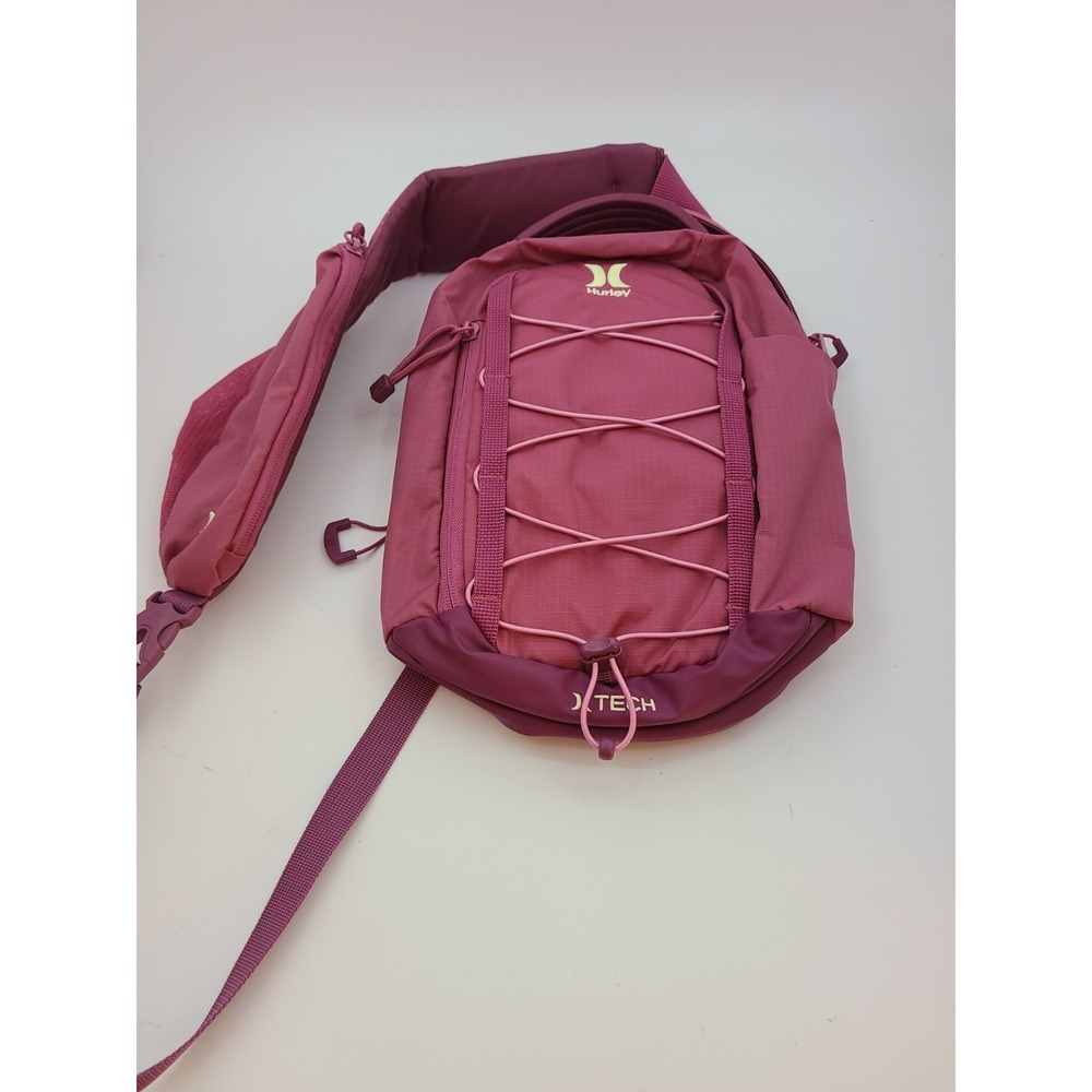 Hurley Terrain Sling Bag Pink features Elastic Bungee Cord System front storage.